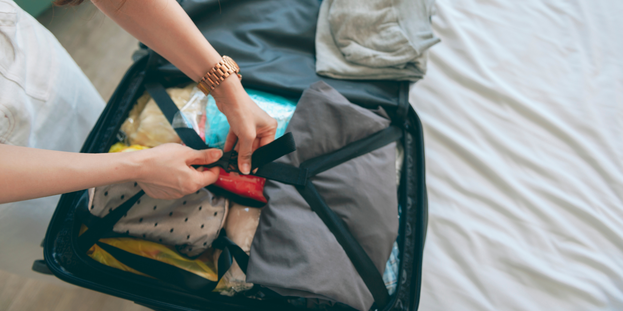 Woman packing to travel to another state for an abortion.