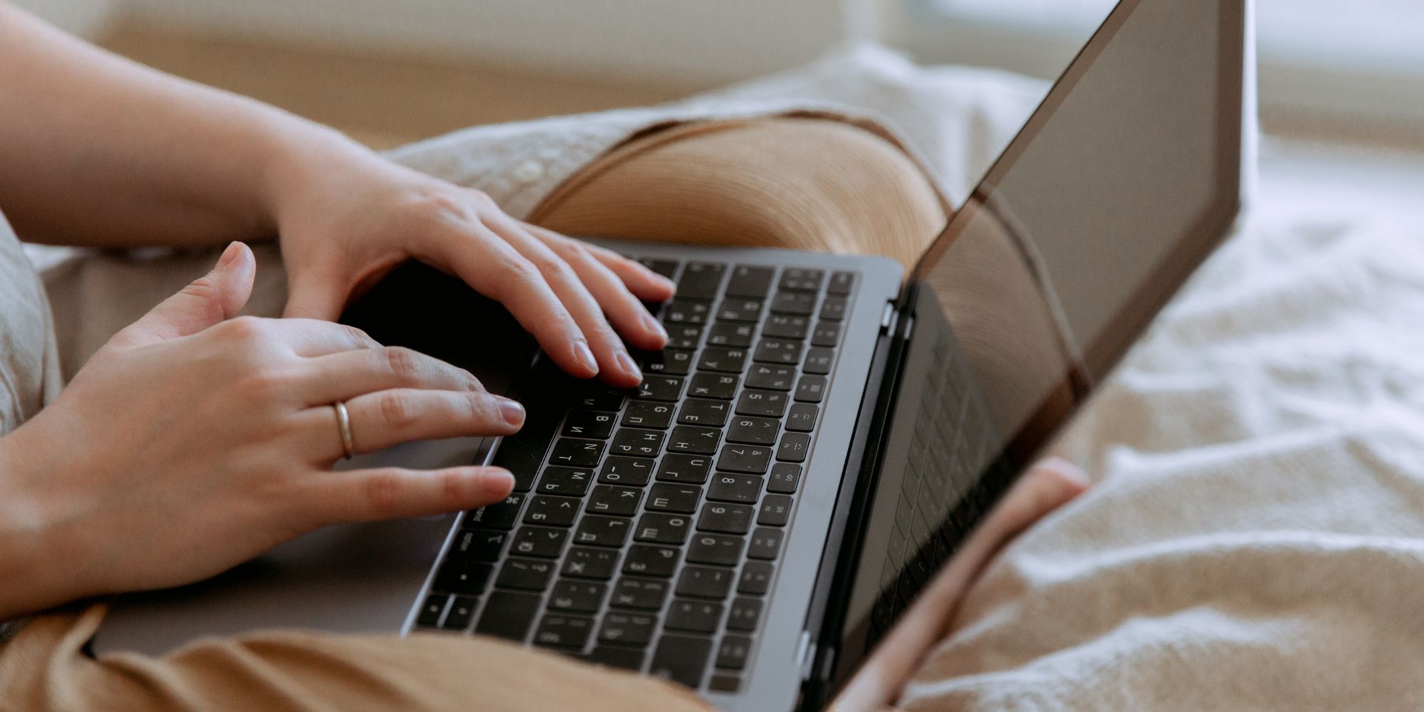 woman texting on laptop
